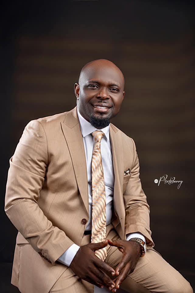 Apostle Otuekong Archibong, Lead Pastor of Winning Grace Family, seated in a tan suit