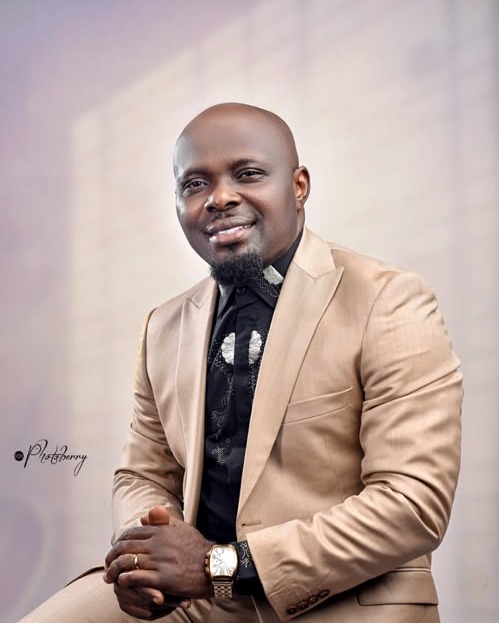 Apostle Otuekong Archibong, Lead Pastor of Winning Grace Family, seated in a tan suit